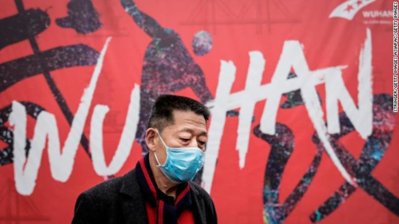 A man wears a mask while out on the street in Wuhan. 