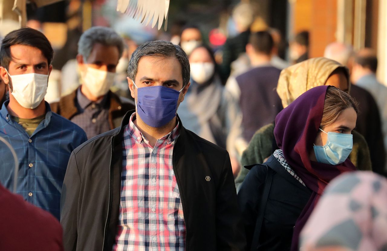 Iranians wear face masks as a Covid-19 coronavirus pandemic precaution, in Iran's capital Tehran on October 19.