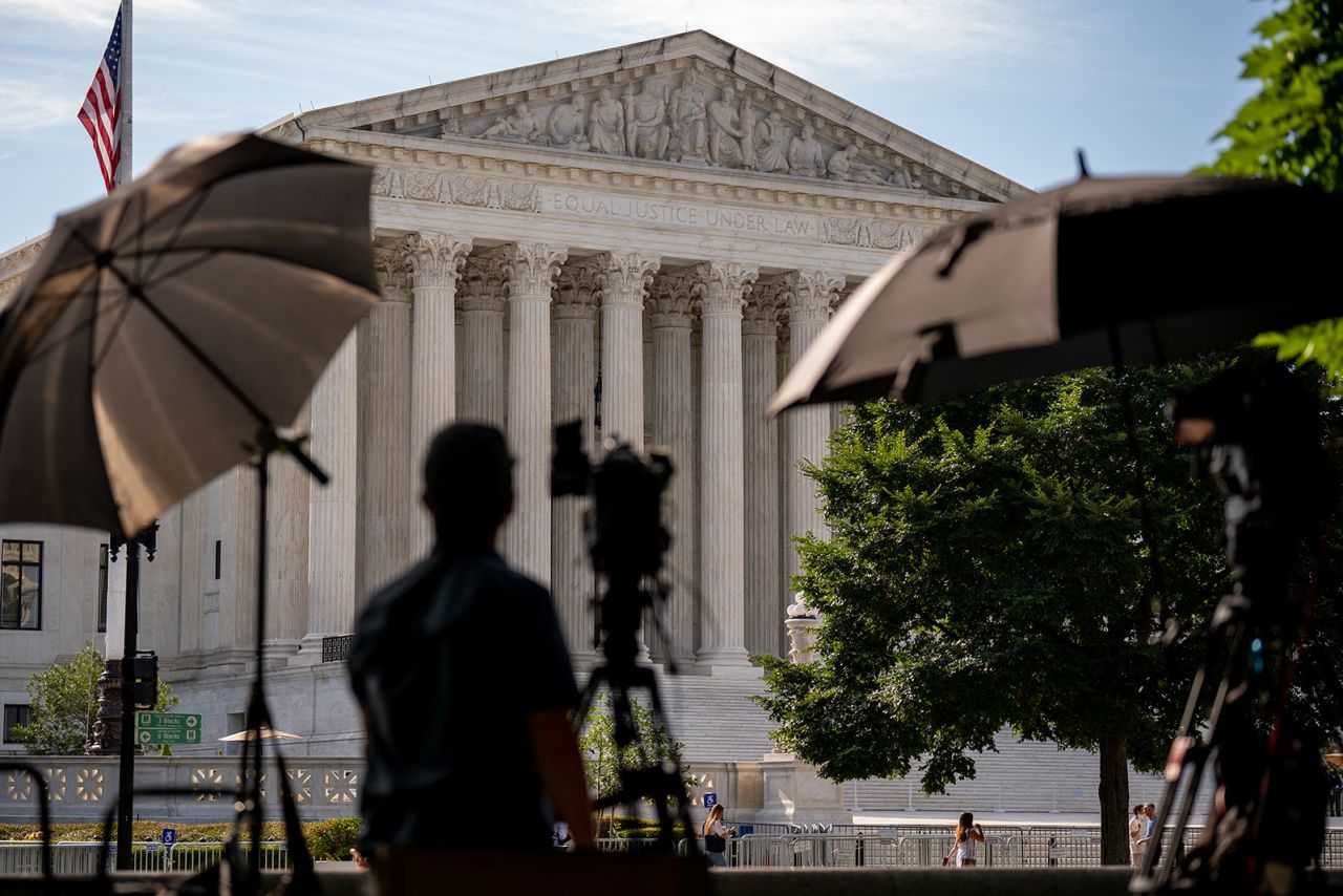 A member of the media sets up near the Supreme Court in Washington, DC on June 20.