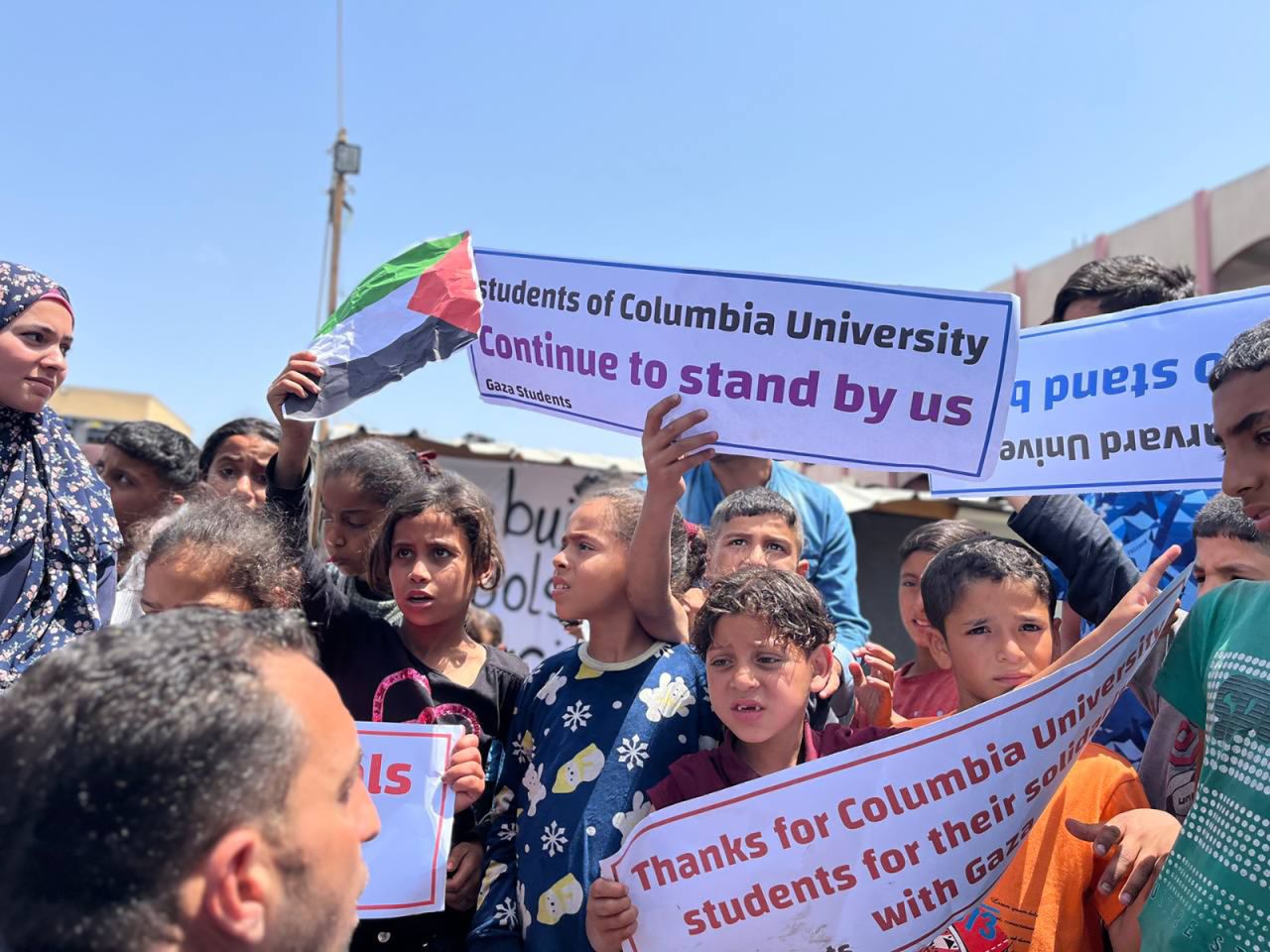 Palestinian students hold signs in Rafah, Gaza, on April 28. 