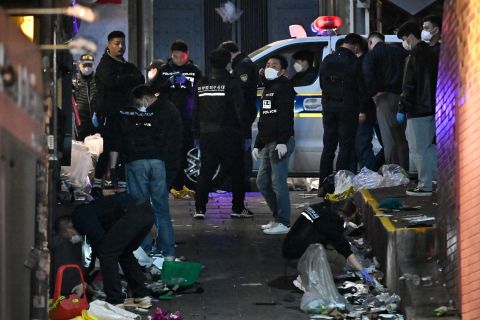 Police investigate the scene in Itaewon on Saturday night.