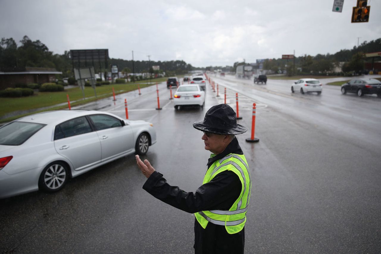 Jack Ross from the South Carolina Highway Patrol directs traffic onto US 501 as the South Carolina government ordered that traffic use all the lanes on the route leading away from the coast to facilitate the evacuation of people ahead of the arrival of Hurricane Florence on Sept. 11, 2018 in Myrtle Beach.