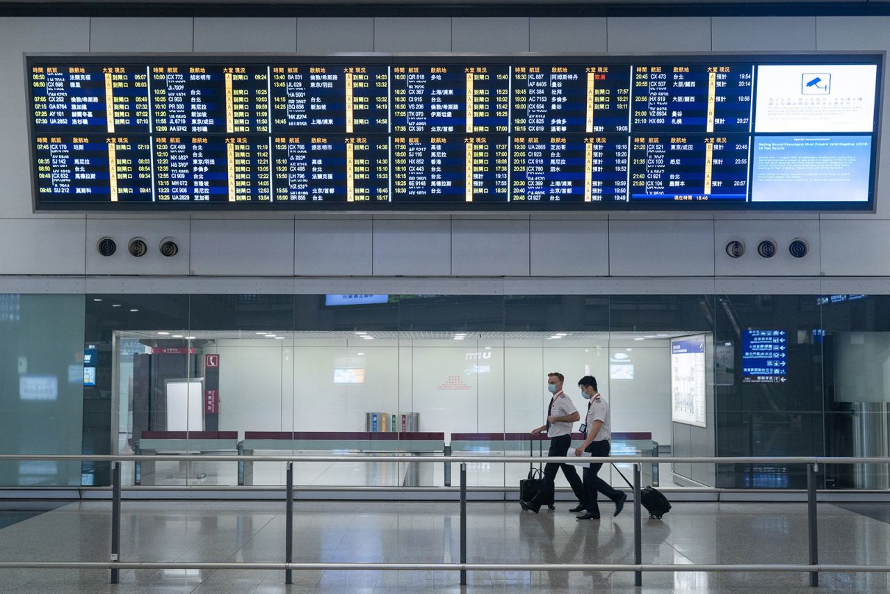 Cathay Pacific pilots exit the arrival hall at Hong Kong International Airport on November 6, 2020.