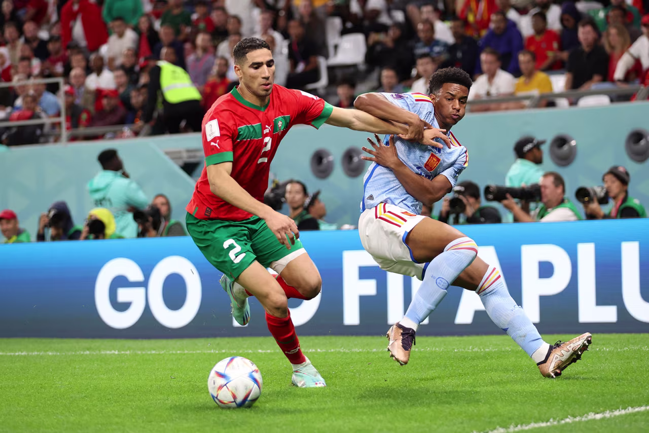 Morocco’s Achraf Hakimi battles for possession with Spain’s Alejandro Balde.