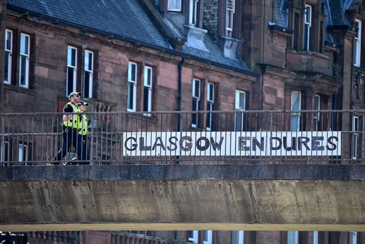 Two police officers walk past a sign at Charing Cross on May 6 in Glasgow, Scotland.