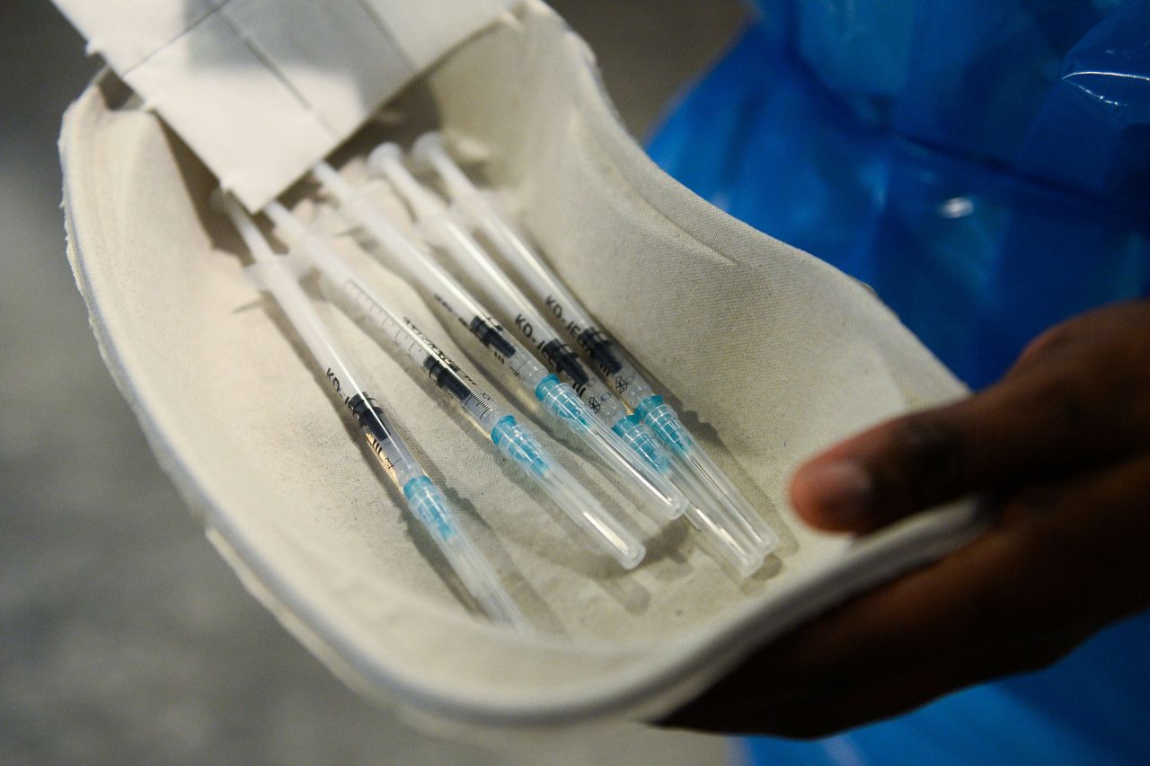 A member of the medical staff prepares doses of the Pfizer/BioNTech coronavirus vaccine at the Notre-Dame hospital in Brussels, Belgium, on December 28.