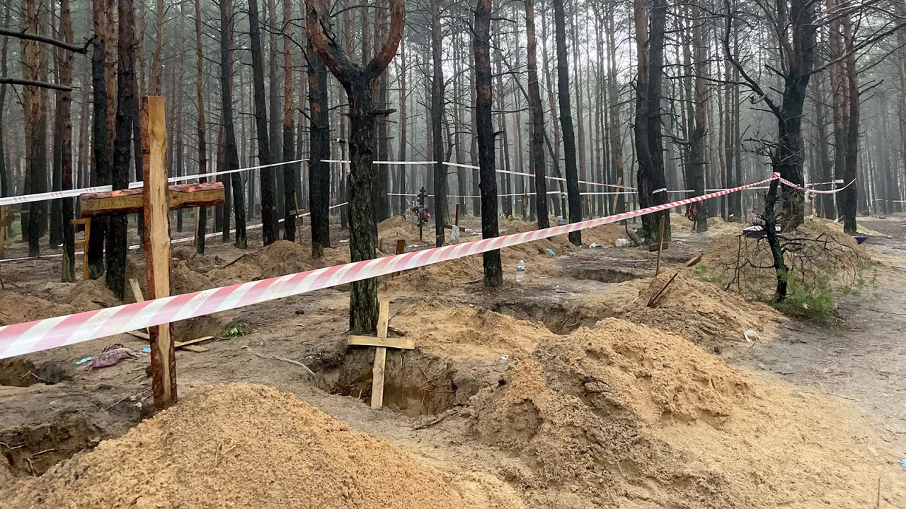 Individual graves are seen throughout the site, some with names and numbers handwritten on the wooden crosses. One grave CNN saw had the number as high as 398.