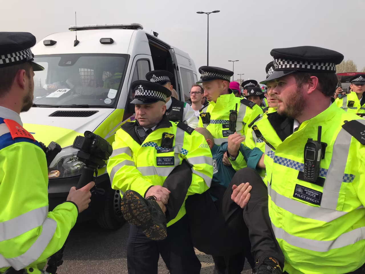 A demonstrator is forcibly removed from Waterloo Bridge after briefly talking to police officers on Wednesday. 