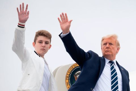 President Donald Trump and his son Barron wave as they board Air Force One on August 16.