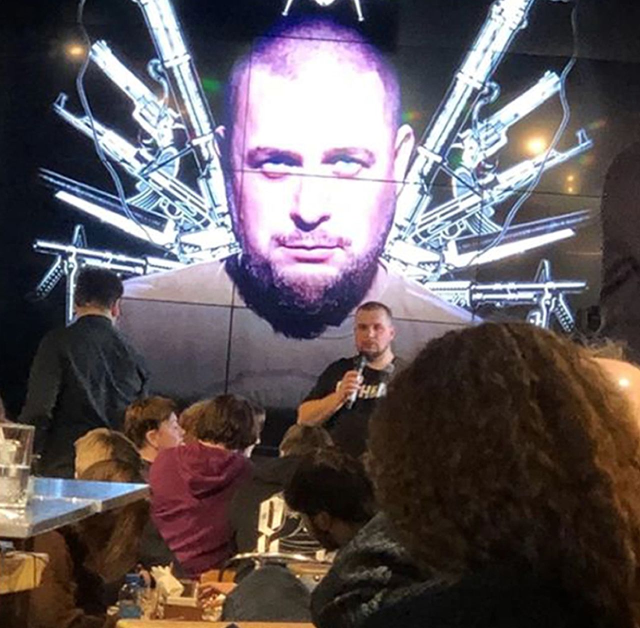 Russian blogger Vladlen Tatarsky speaks during a party in front of projection of an image of him, before an explosion at a cafe in St. Petersburg, Russia, on April 2.