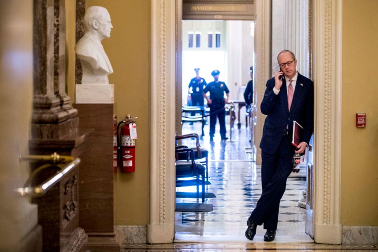 White House Legislative Affairs Director Eric Ueland speaks on a phone on Capitol Hill, Monday, March 23, in Washington. 