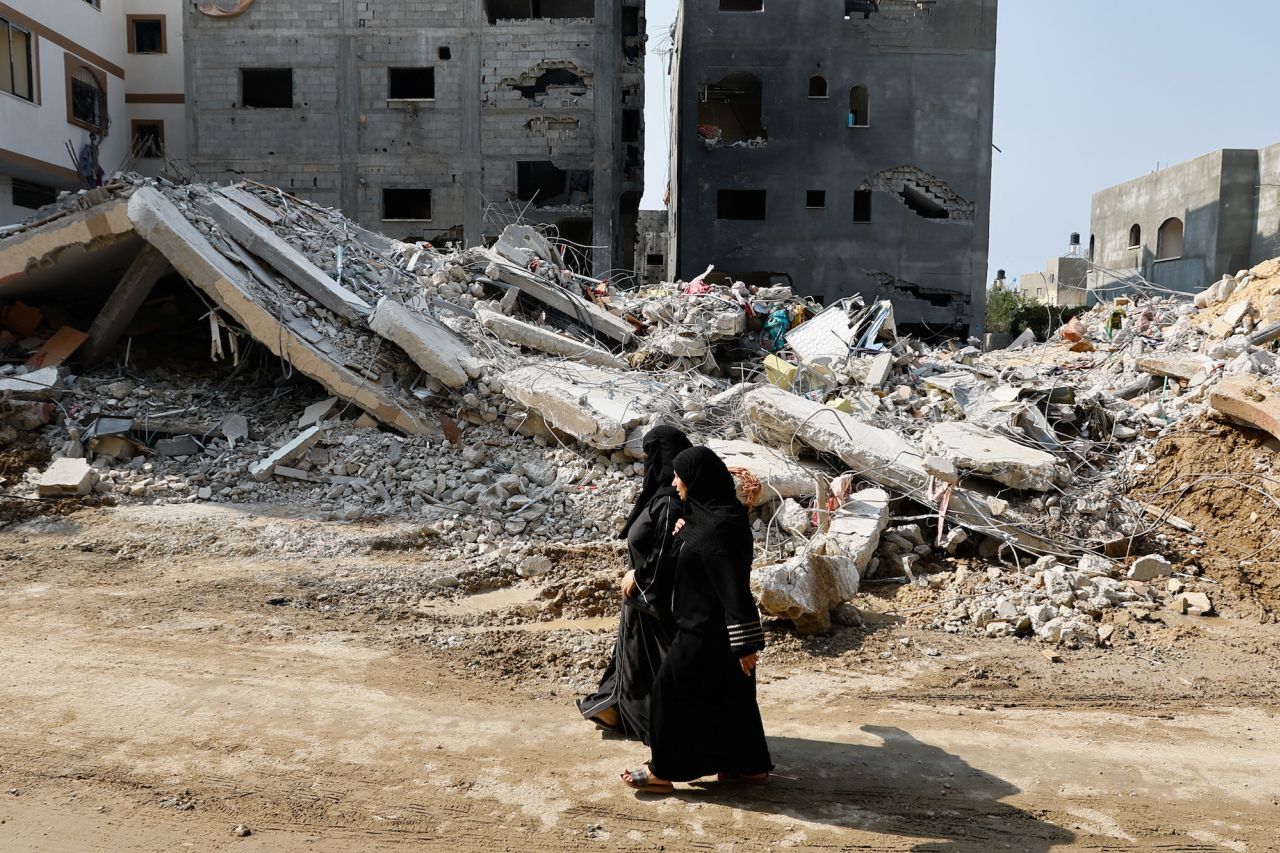 Women are seeing walking by destroyed buildings in southern?Gaza?on Sunday.