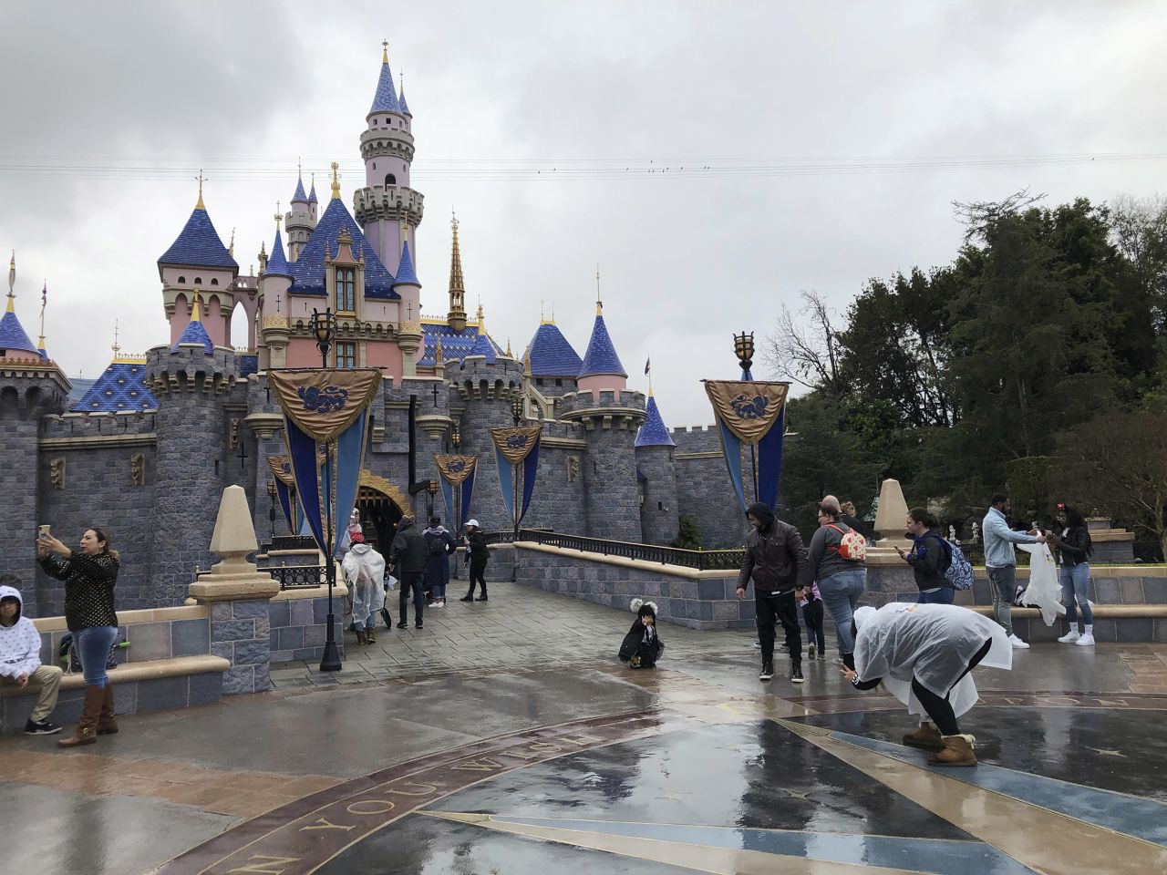 Visitors take photos at Disneyland in Anaheim, California, on Friday, March 13. 