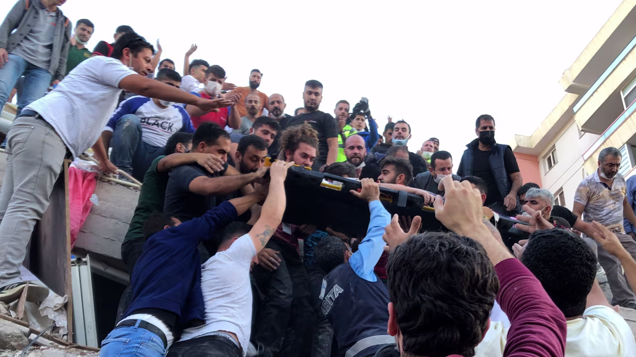 People carry a wounded person from the debris of a collapsed building in Izmir, Turkey, on October 30.