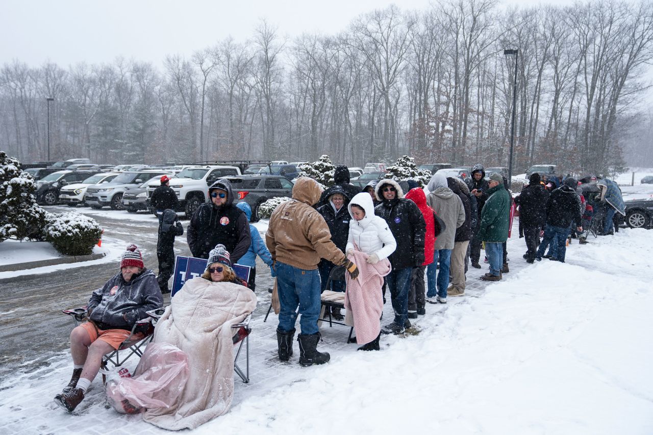 Supporters of Republican presidential candidate former President Donald Trump wait in line to enter a campaign event in Atkinson, New Hampshire, during a winter snowstorm on Tuesday.