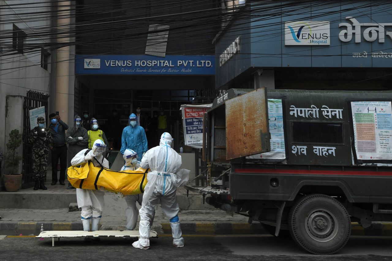 Army personnel load into a vehicle the body of a person who died from Covid-19 in Kathmandu, Nepal, on May 5.