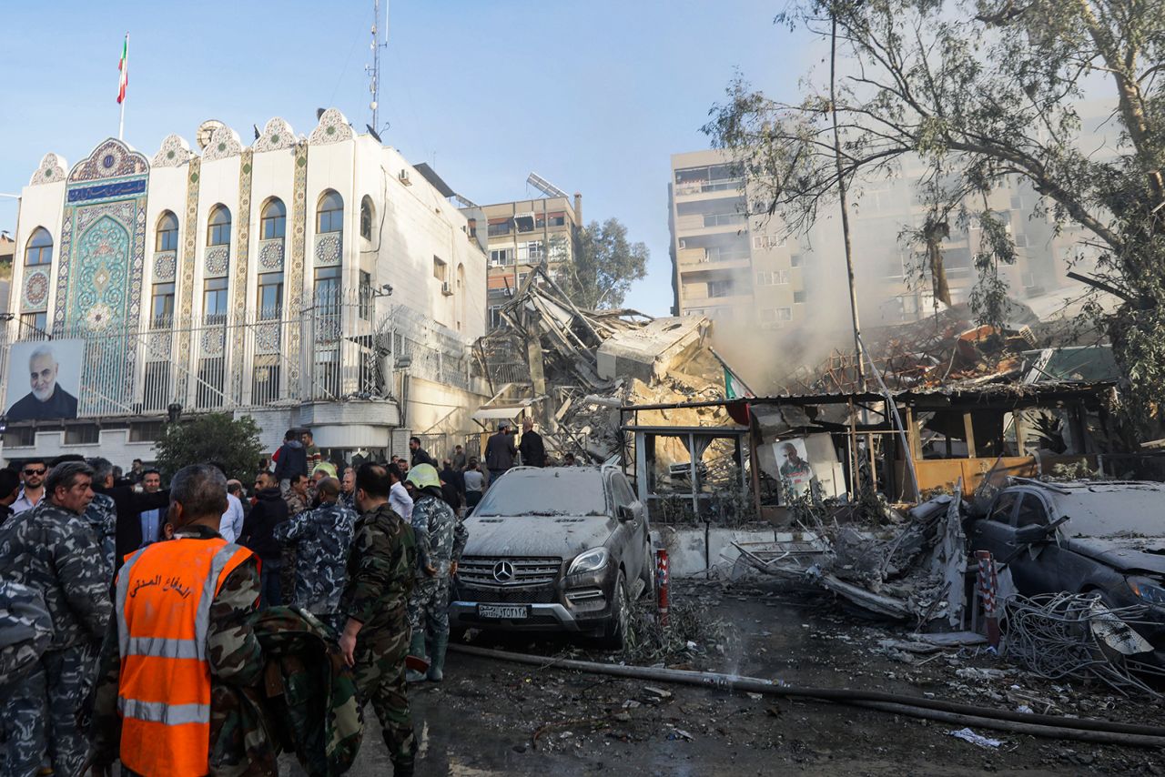 Emergency and security personnel inspect the site of strikes which hit a building next to the Iranian embassy in Syria's capital Damascus, on April 1.