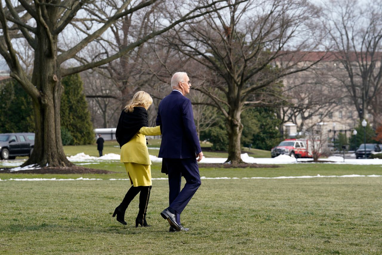 President Joe Biden, right, and First Lady Jill Biden walk on the South Lawn of the White House before boarding Marine One in Washington, DC, on Tuesday.