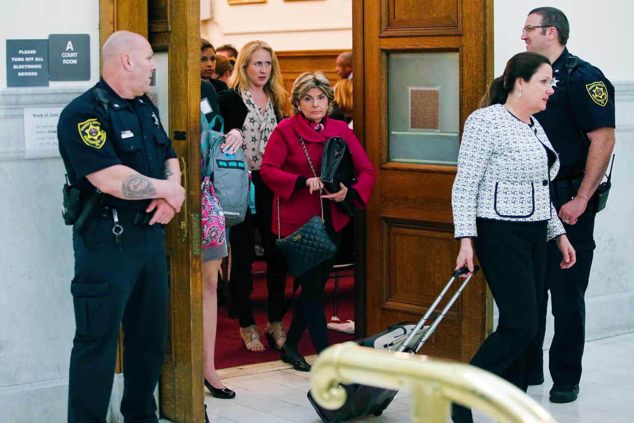 Attorney Gloria Allred, center, walks out of the courtroom at Montgomery County courthouse during Bill Cosby's trial in 2017.