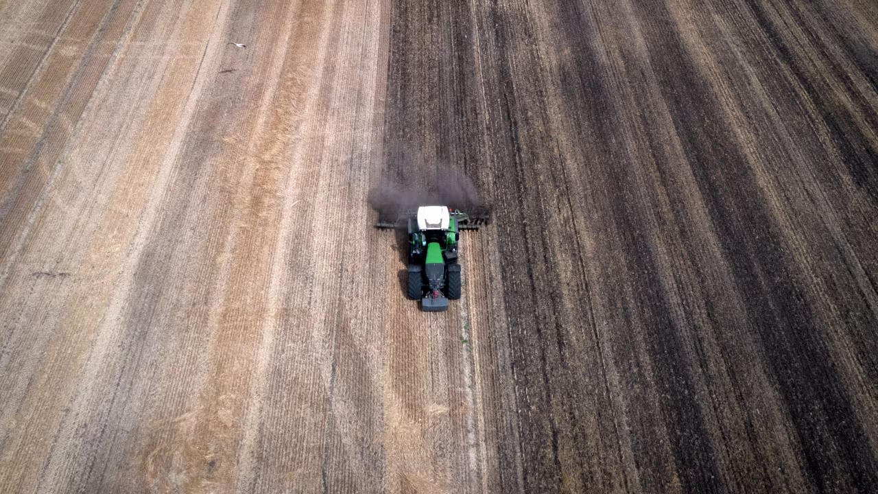 A tractor works the field on a private farm in Zhurivka, Kyiv region, Ukraine, Thursday, Aug. 10, 2023.