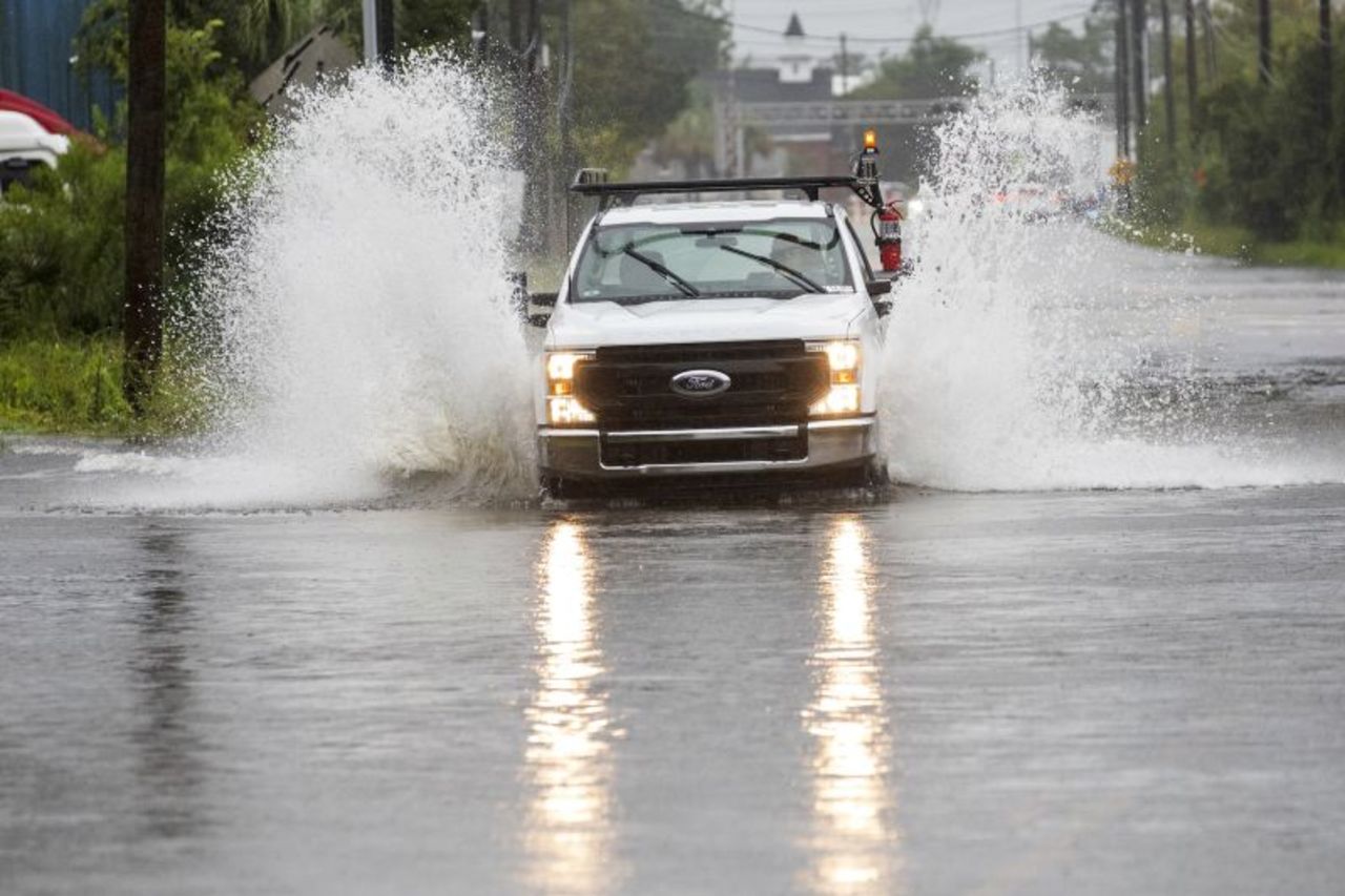 A truck sprays flood water n Charleston as Tropical Storm Debby approaches on Tuesday.