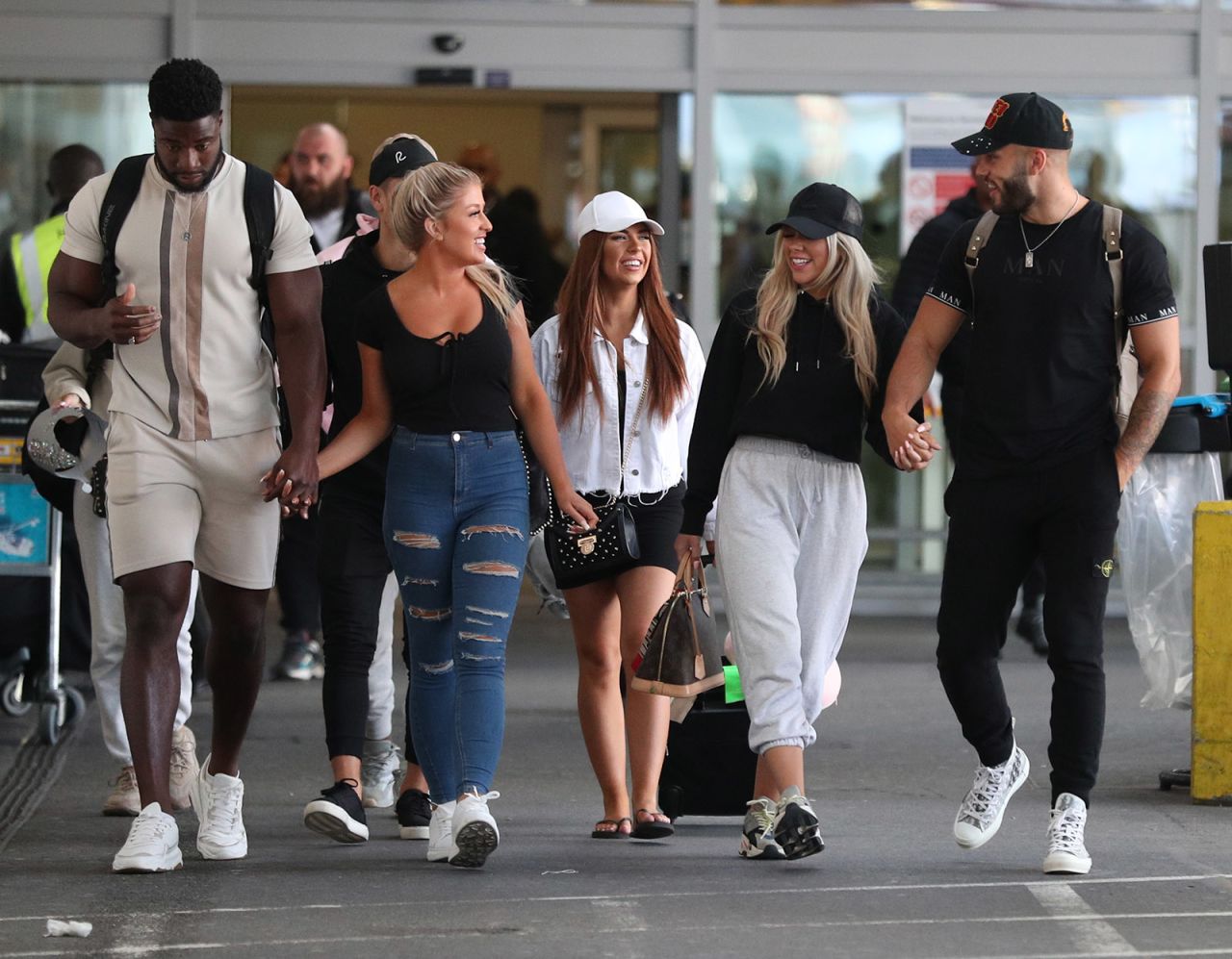 Love Island contestants walk together after arriving at Heathrow Airport in London following the final of the reality TV show on February 26.