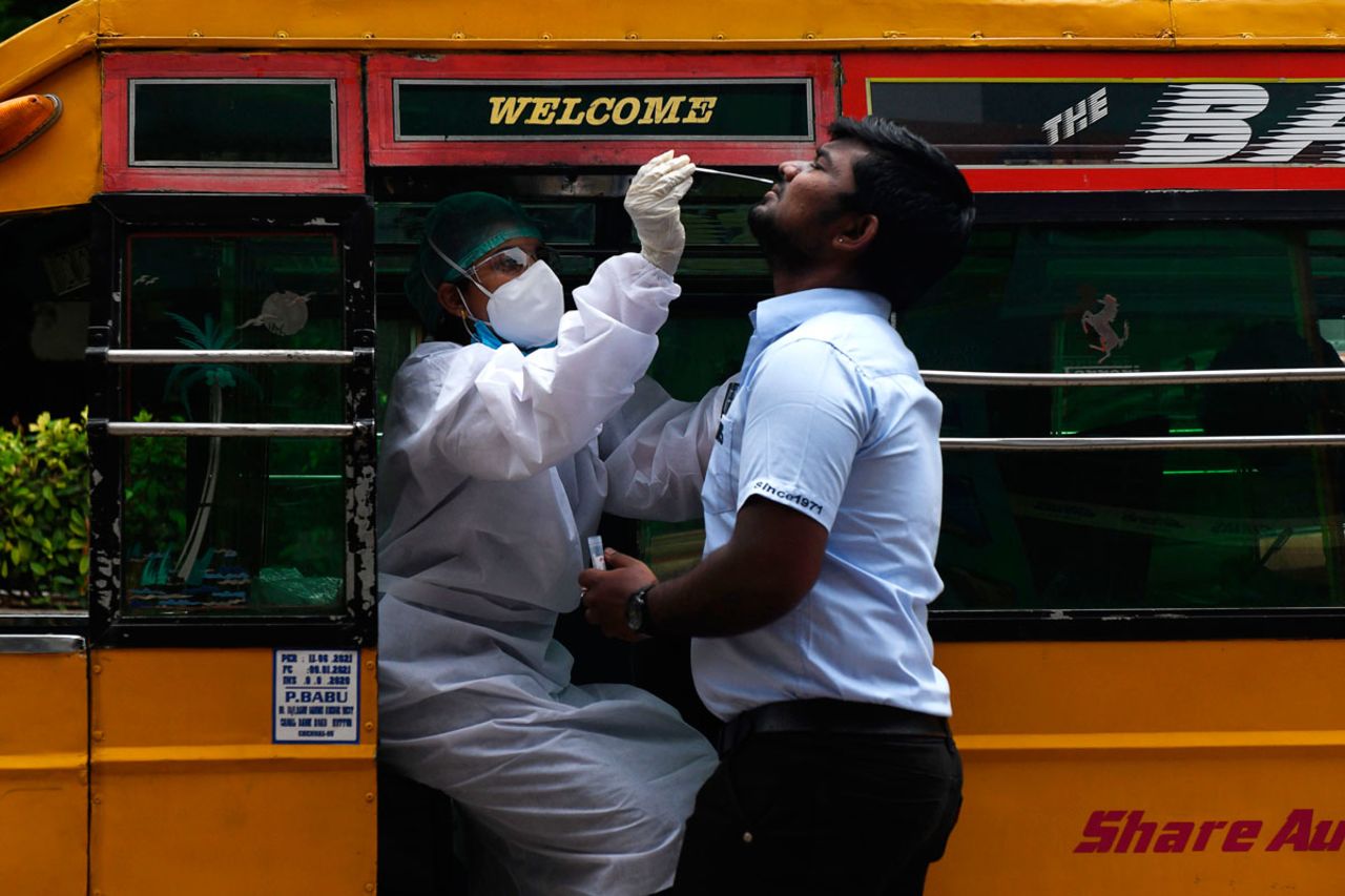 A health worker in an auto-rickshaw collects a swab sample for a coronavirus test outside a commercial centre in Chennai, Tamil Nadu, on September 12.