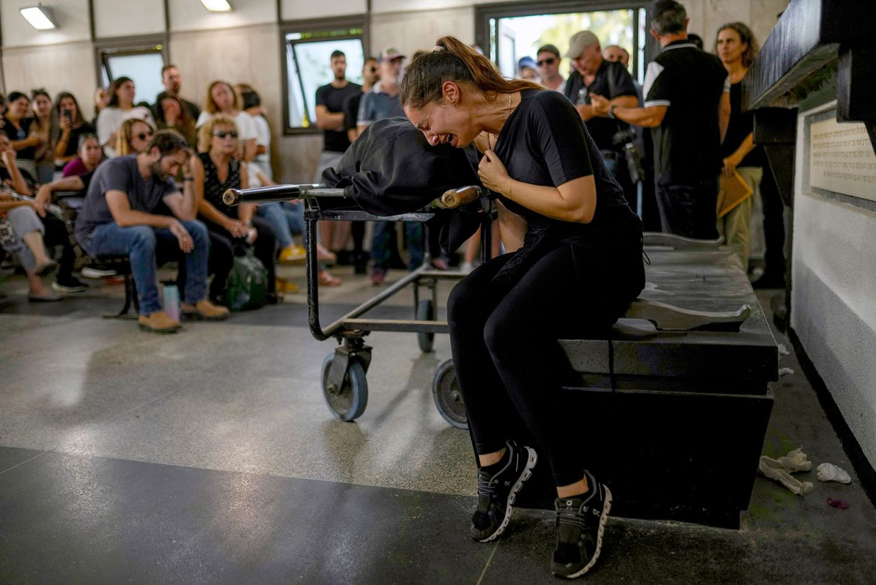 Mourners react beside the body of Mapal Adam during her funeral in Tel Aviv, Israel, on October 11. 