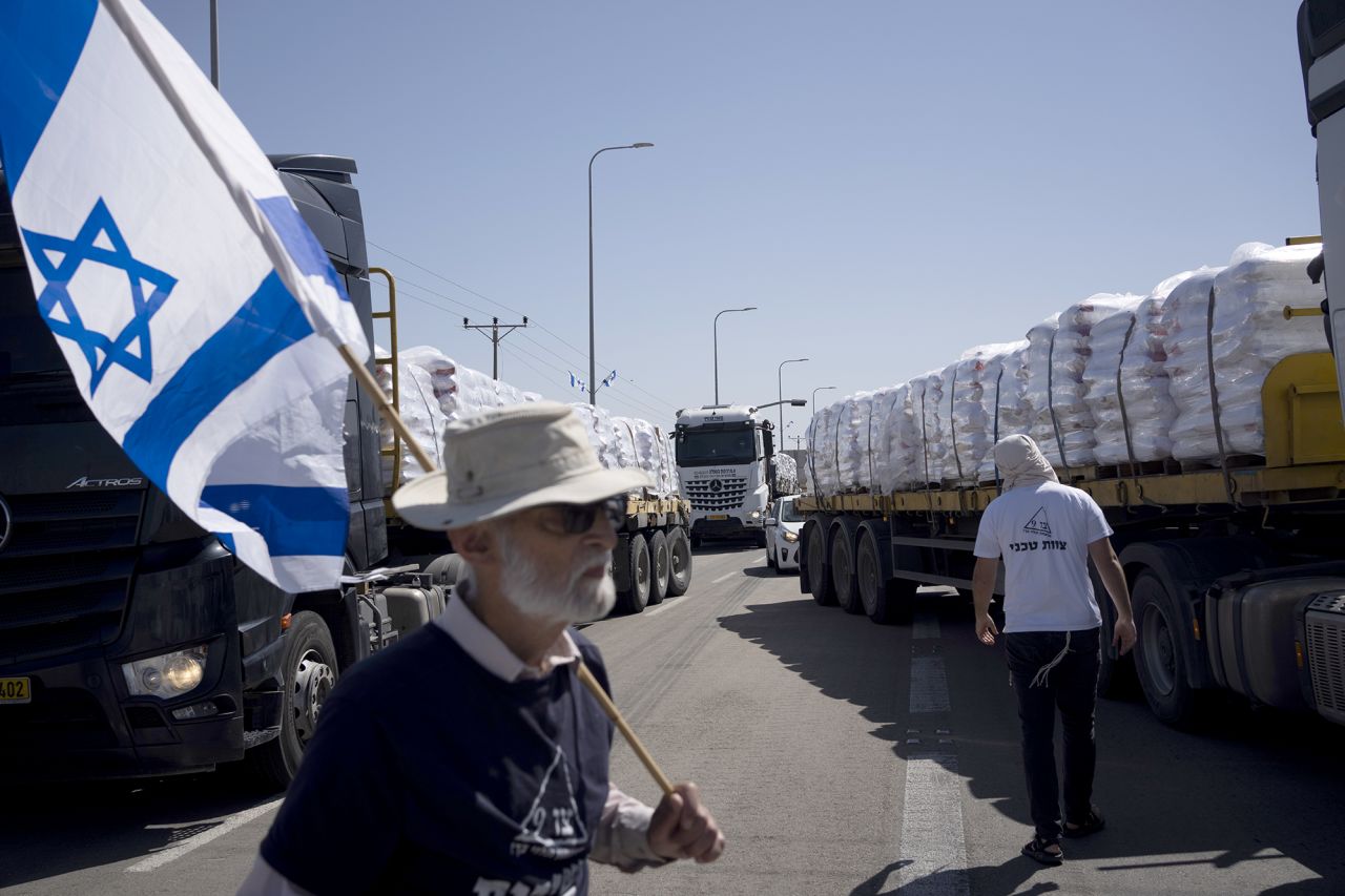 People block a road as they try to stop trucks carrying humanitarian aid from entering into Gaza, in an area near the Kerem Shalom border crossing in southern Israel, on May 9.