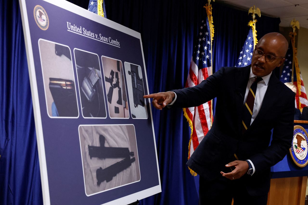 New York Southern District Attorney Damian Williams points at a poster during a press conference in New York on Tuesday. 