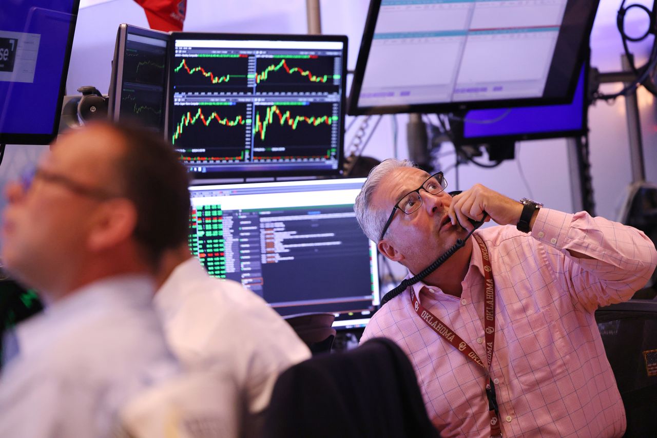 Traders work on the floor of the New York Stock Exchange during morning trading on August 6.