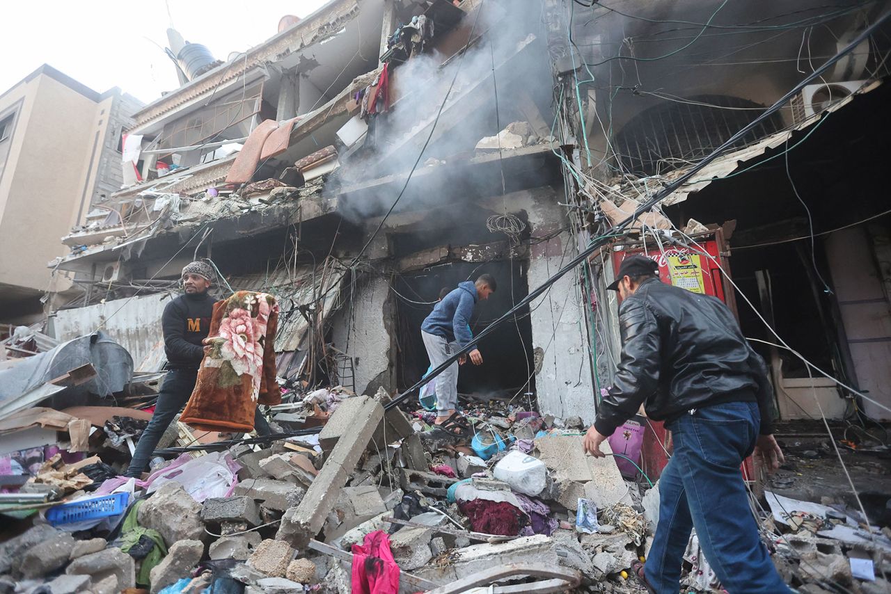 Palestinians inspect the destruction caused by air strikes on their homes in Khan Yunis in Gaza on Monday, December 4.