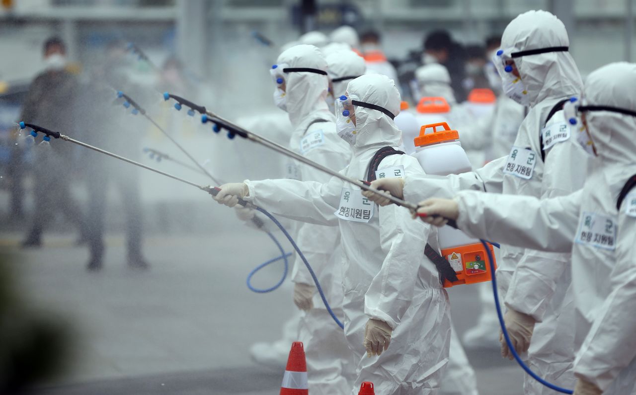 Army soldiers wearing protective suits spray disinfectant to prevent the spread of the new coronavirus at the Dongdaegu train station in Daegu, South Korea, Saturday, February 29. 