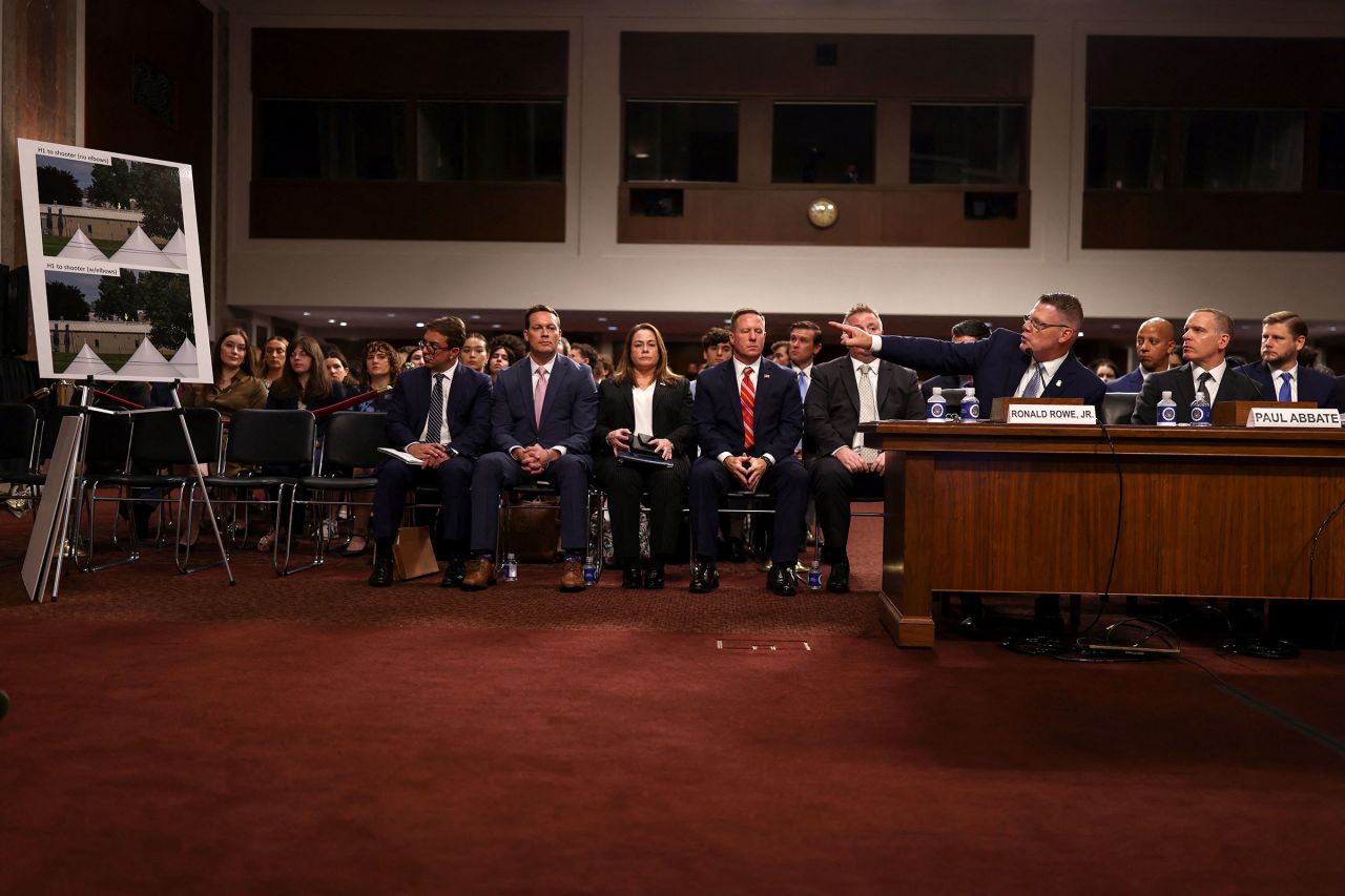 Rowe points to images on poster board during a hearing on Tuesday in Washington, DC.