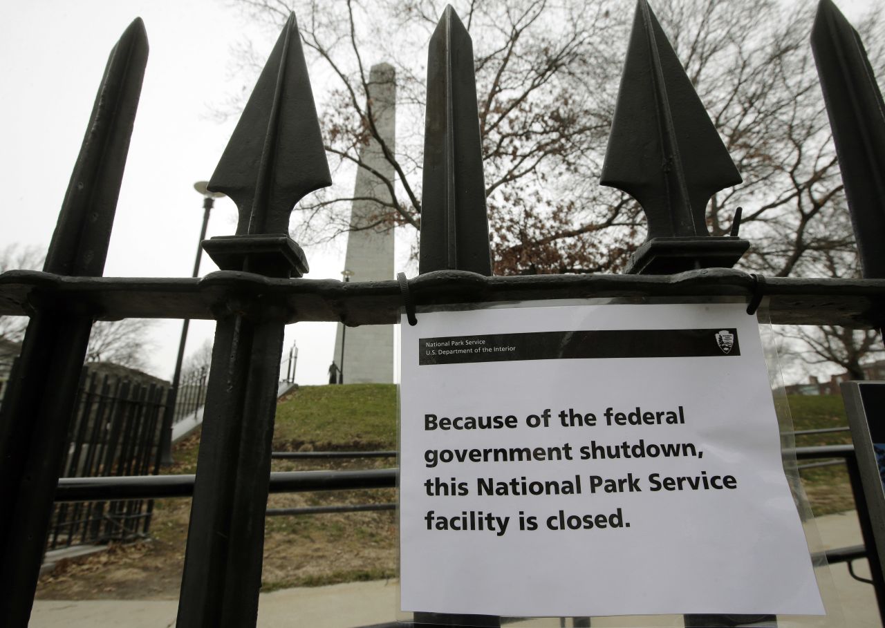 A sign is posted on a fence near an entrance to the Bunker Hill Monument on Dec. 24 in Boston