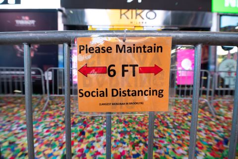 A social distancing sign is seen during the 2021 New Year's Eve celebration in Times Square New York City, on December 31, 2020. 