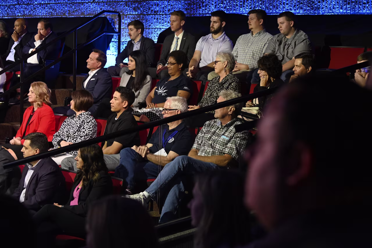 Audience members listen as former Vice President Mike Pence responds to a question.