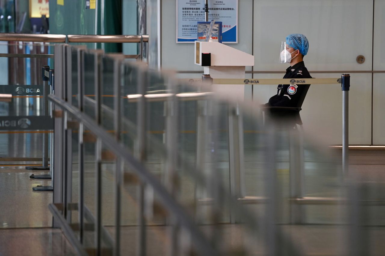 A security guard watches over the empty international arrivals channel at Beijing airport on November 6.