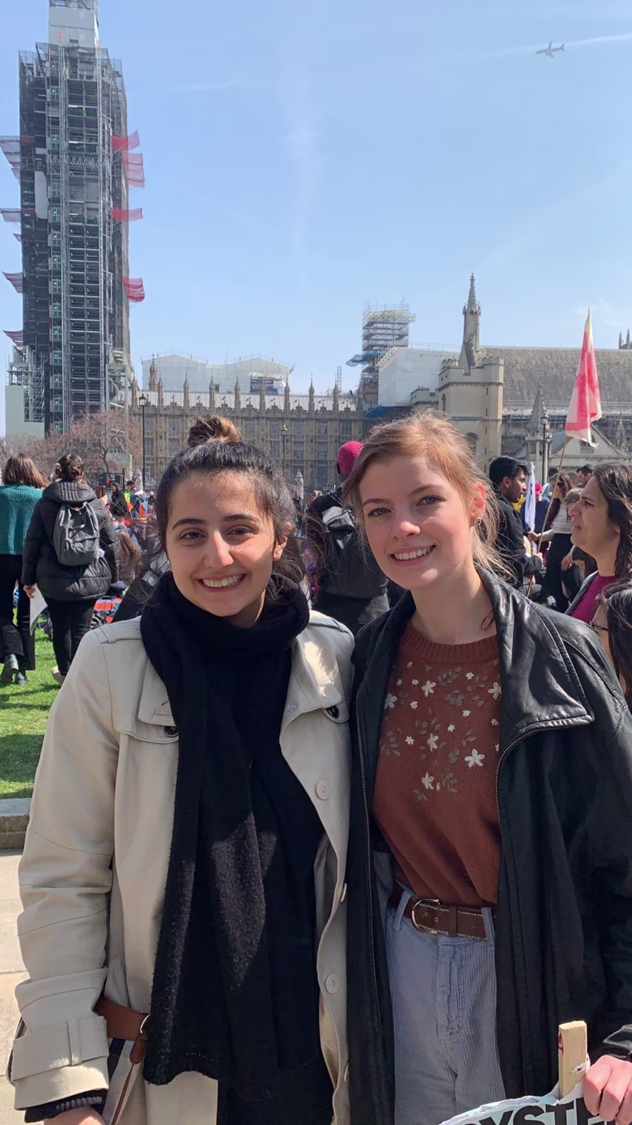Niki Shahab (left) and Imogen Gaskell (right) protest in front of Britain's Houses of Parliament.