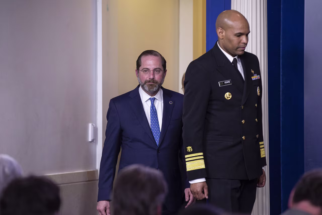From left, Health and Human Services Secretary Alex Azar and US Surgeon General Jerome Adams arrive at a coronavirus task force briefing on March 9.