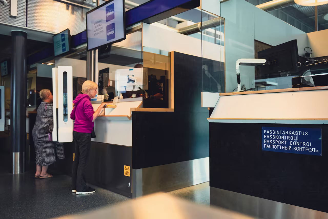 Russian tourists have their passport checked at the Nuijamaa border crossing in Finland on July 28.