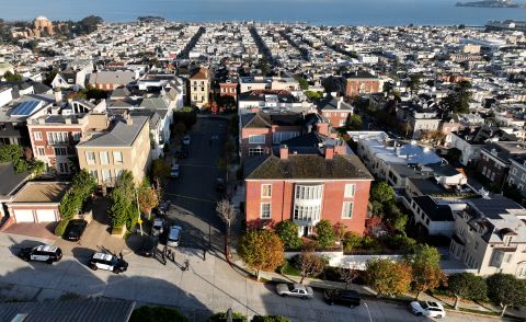 In an aerial view, San Francisco police officers and FBI agents gather in front of House Speaker Nancy Pelosi's home in San Francisco, California on Friday.