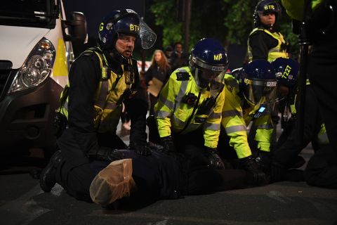 A protester is placed in a spit hood as he is restrained by officers during a Black Lives Matter protest on June 7, in London.