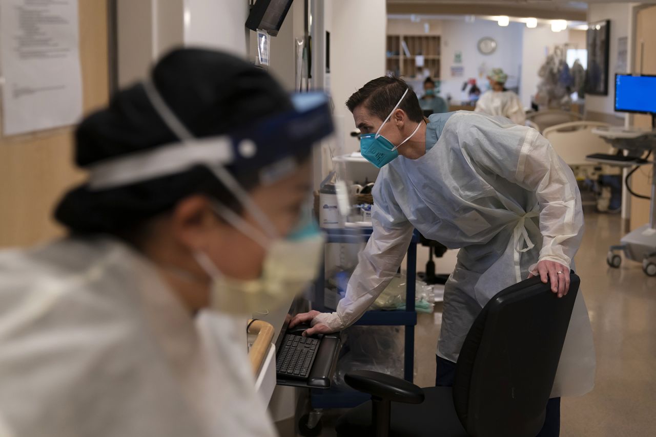 A nurse looks at his computer while working in a Covid-19 unit at Providence Holy Cross Medical Center in the Mission Hills section of Los Angeles on Thursday, Nov. 19.