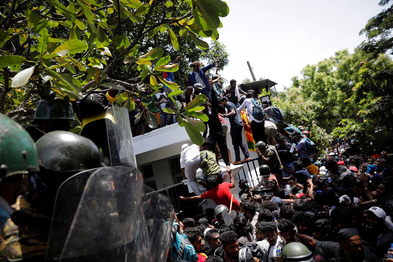 Protestors climb the front gate of?Sri?Lanka's Prime Minister Ranil Wickremesinghe's office during a protest in Colombo,?Sri?Lanka, on?July 13.