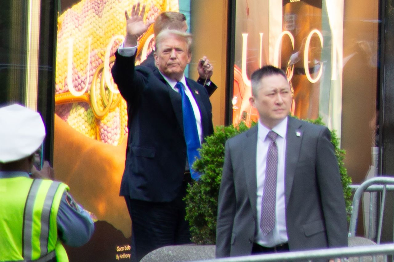 Trump waves as he returns to Trump Tower on Thursday.