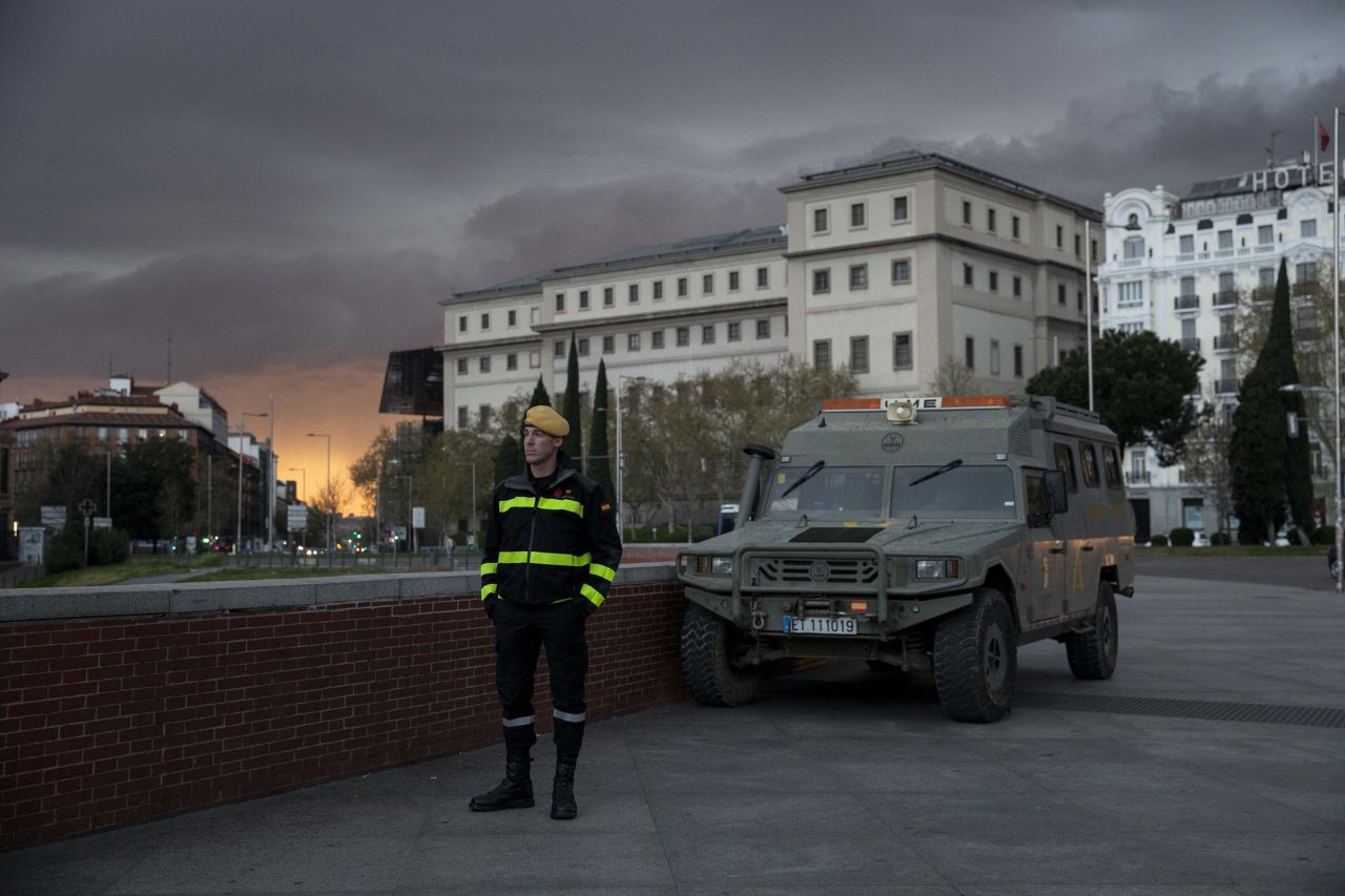 A member of Spanish Military Emergency Unit (UME) stands guard outside a train station in Madrid, Spain, on March 15.