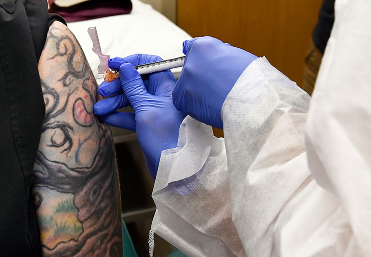 A nurse gives a volunteer an injection as a study of a possible COVID-19 vaccine developed by the National Institutes of Health and Moderna Inc., gets underway in Binghamton, N.Y on July 27, 2020.