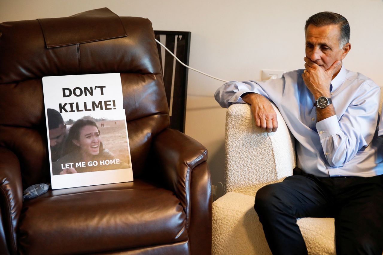 Yaakov Argamani, father of hostage Noa Argamani, sits next to a poster of his daughter in Tel Aviv, Israel, in November 2023. 