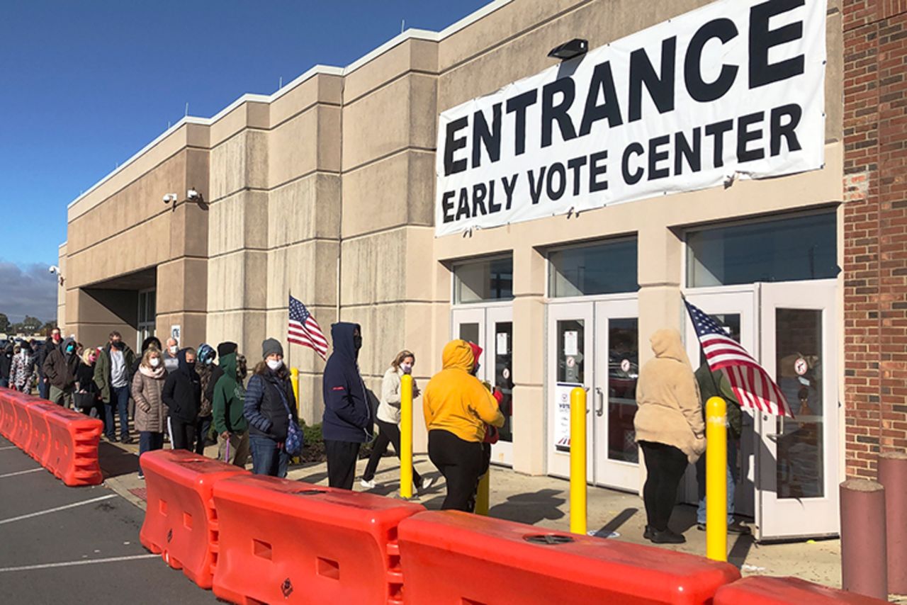 People bundled against the cold stand in a slowly moving line to cast early votes at the Franklin County Board of Elections on Friday, Oct. 30, 2020, in Columbus, Ohio.